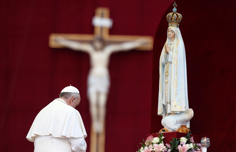 Pope Francis pays homage to the statue of St. Mary of Fatima at the end of the Marian prayer in St. Peter's square at the Vatican, Saturday, Oct. 12, 2013. (AP Photo/Riccardo De Luca)